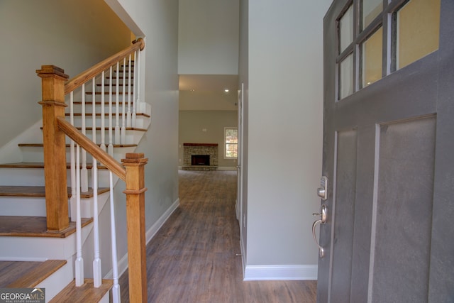 entrance foyer with a fireplace and dark hardwood / wood-style floors