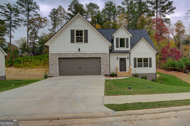 modern inspired farmhouse featuring a garage and a front yard