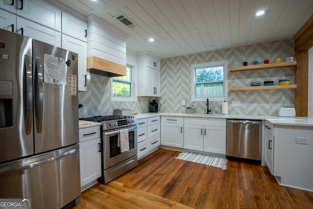 kitchen featuring a wealth of natural light, dark wood-type flooring, white cabinets, and stainless steel appliances