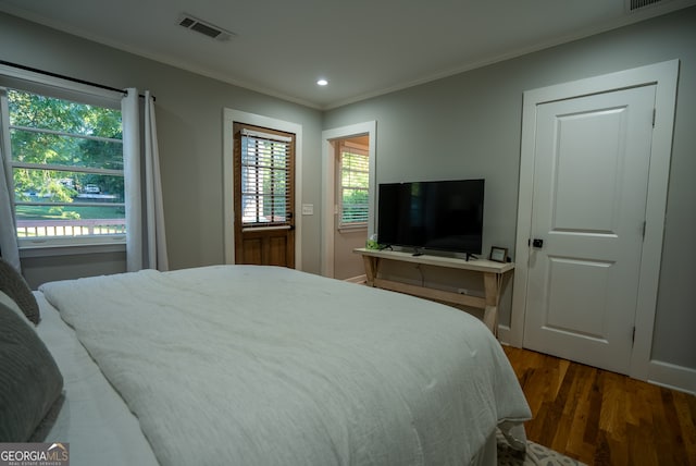 bedroom featuring dark wood-type flooring and ornamental molding