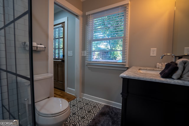 bathroom featuring vanity, tile patterned floors, and toilet