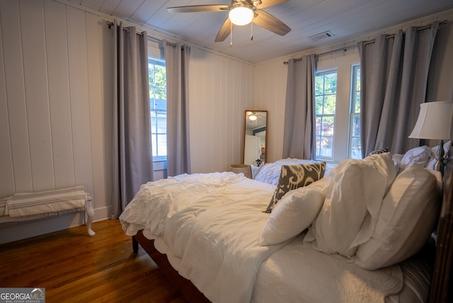 bedroom featuring dark wood-type flooring, ceiling fan, multiple windows, and wood ceiling