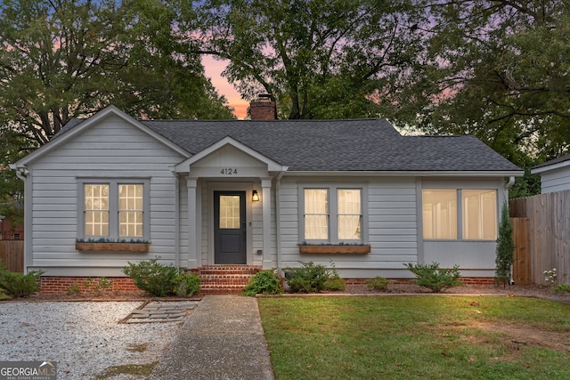 ranch-style home featuring a lawn