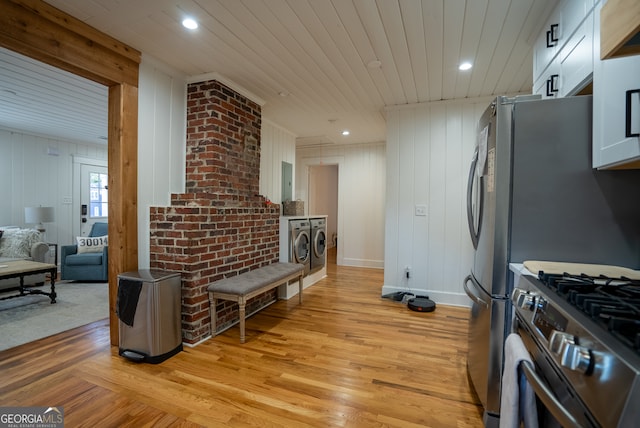 kitchen with stainless steel appliances, light hardwood / wood-style floors, white cabinetry, and wood ceiling