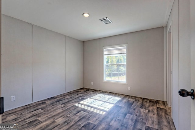 unfurnished room with dark hardwood / wood-style floors