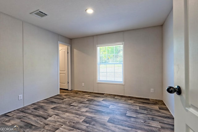 spare room with dark hardwood / wood-style flooring