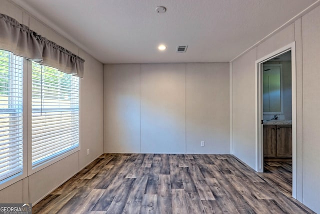 spare room featuring dark hardwood / wood-style flooring