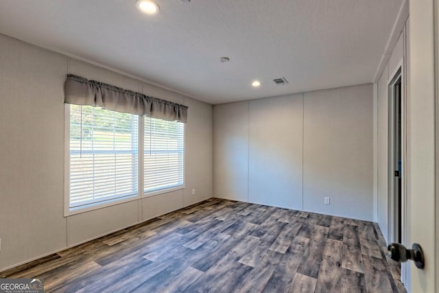 unfurnished room with hardwood / wood-style flooring