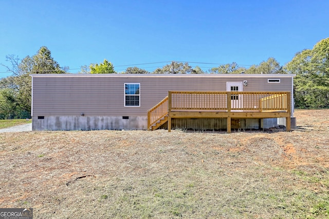 rear view of property with a wooden deck