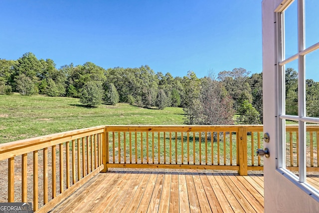 wooden terrace featuring a yard