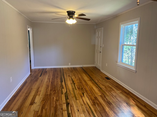 unfurnished room with ceiling fan, dark hardwood / wood-style flooring, and ornamental molding