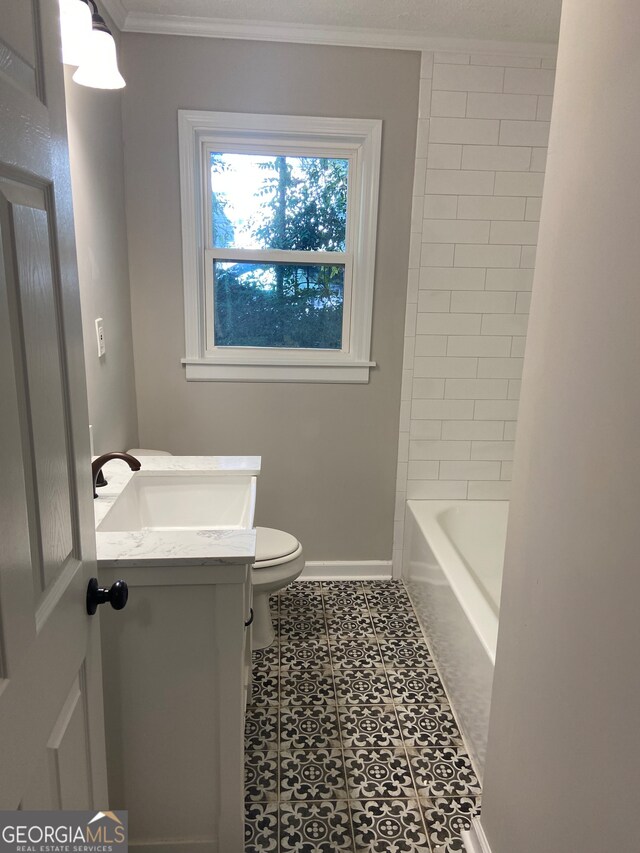 bathroom with toilet, vanity, tile patterned flooring, and ornamental molding