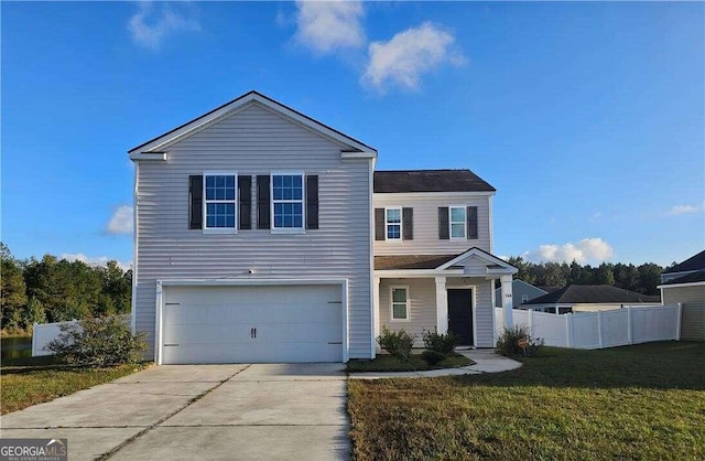 view of property featuring a front lawn and a garage