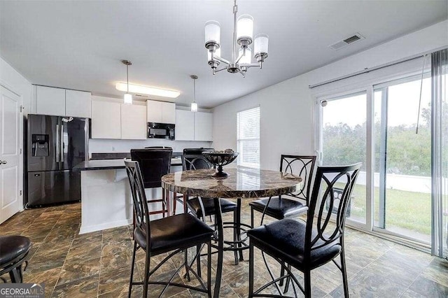 dining space with a chandelier