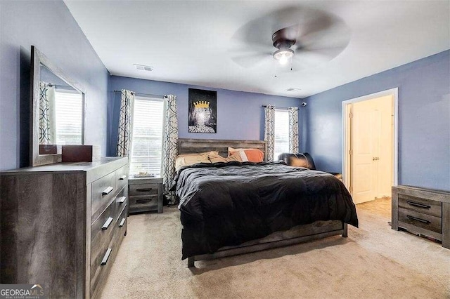 bedroom with light carpet and ceiling fan