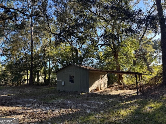 view of home's exterior with an outbuilding