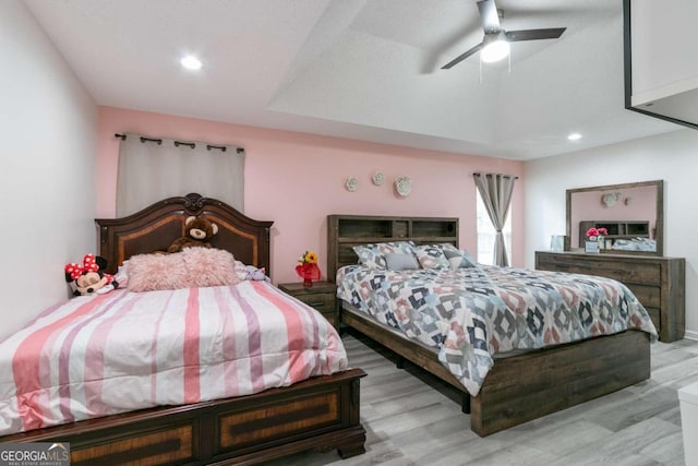 bedroom with light hardwood / wood-style flooring, lofted ceiling, and ceiling fan