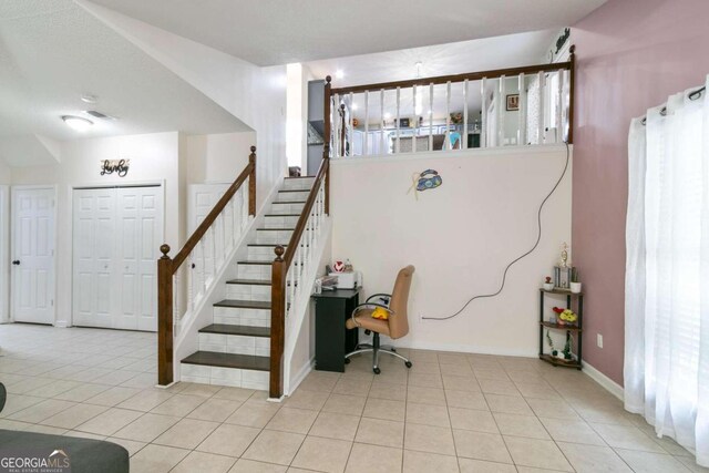 bedroom with a drop ceiling and tile patterned flooring