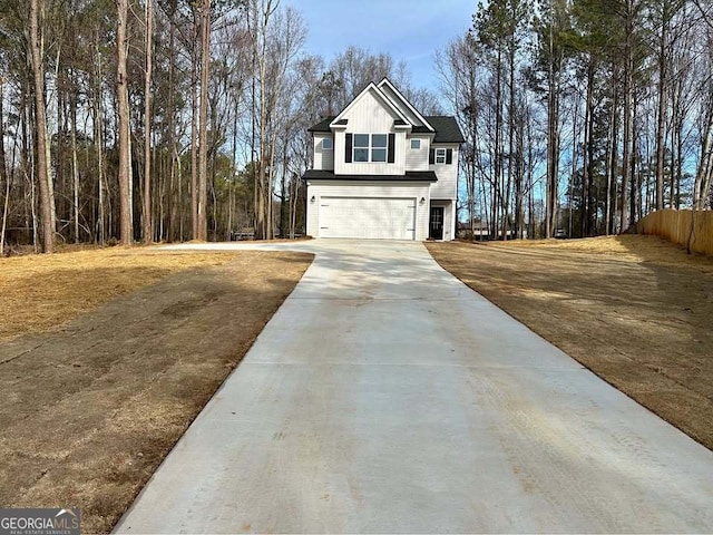 view of side of home with driveway, board and batten siding, and an attached garage