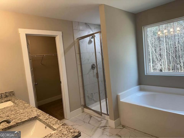 bathroom featuring baseboards, marble finish floor, a spacious closet, a shower stall, and a bath