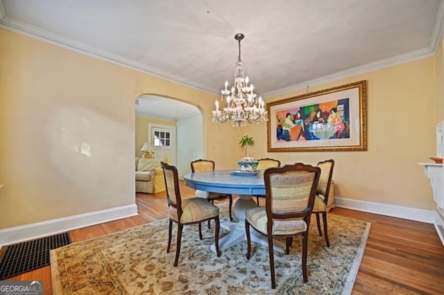 dining area featuring ornamental molding and wood-type flooring