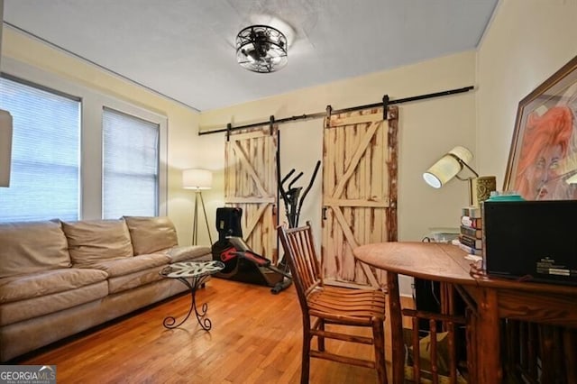 office featuring hardwood / wood-style floors and a barn door