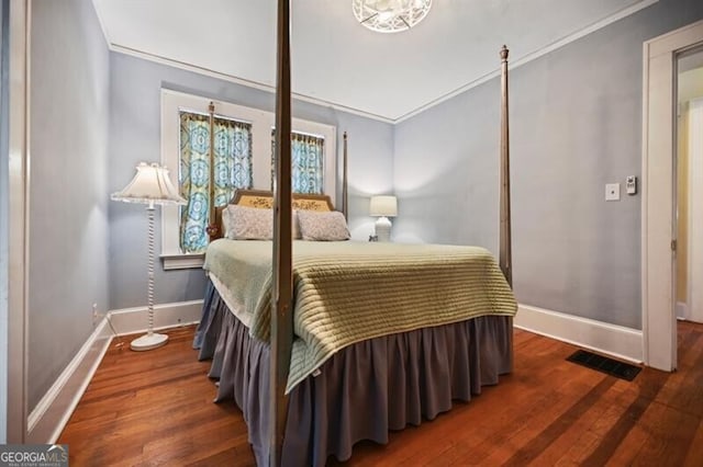 bedroom featuring ornamental molding and hardwood / wood-style floors