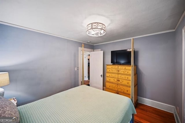 bedroom featuring crown molding and dark wood-type flooring