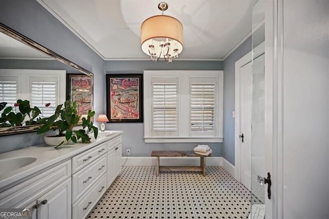 bathroom featuring vanity, ornamental molding, and an inviting chandelier