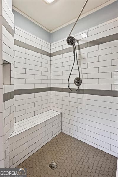 bathroom with tiled shower