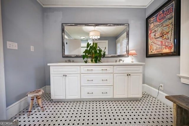 bathroom with a notable chandelier, vanity, tile patterned floors, and crown molding