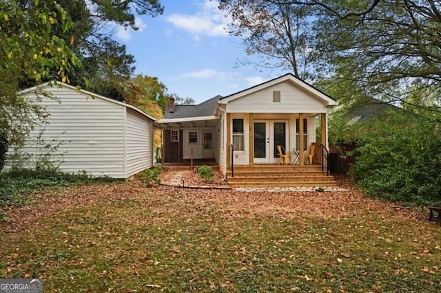 rear view of property with french doors and covered porch