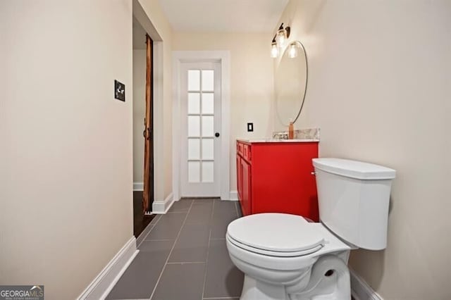 bathroom with vanity, tile patterned floors, and toilet