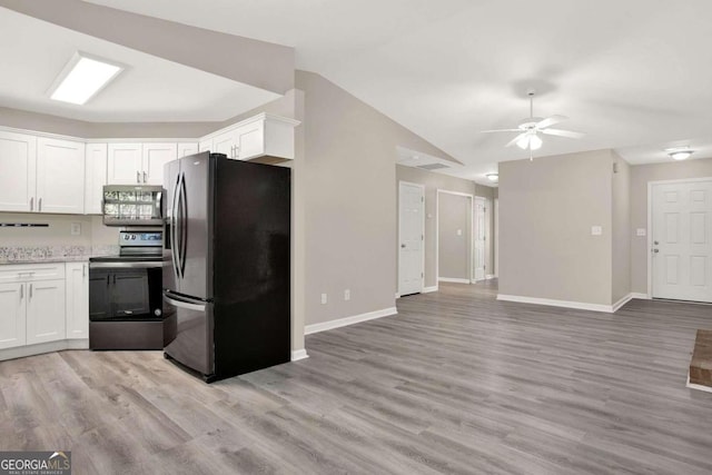 kitchen featuring white cabinets, appliances with stainless steel finishes, and light hardwood / wood-style flooring