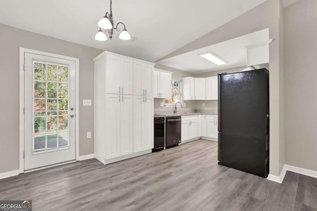 kitchen featuring white cabinets, light hardwood / wood-style floors, black appliances, and lofted ceiling