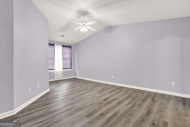 empty room with hardwood / wood-style floors, ceiling fan, and vaulted ceiling