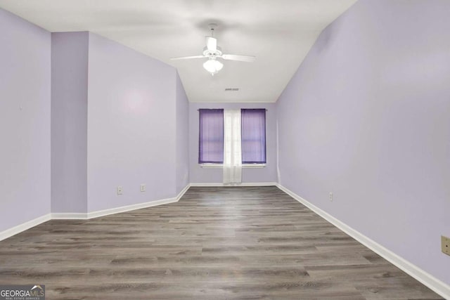 empty room with wood-type flooring, vaulted ceiling, and ceiling fan