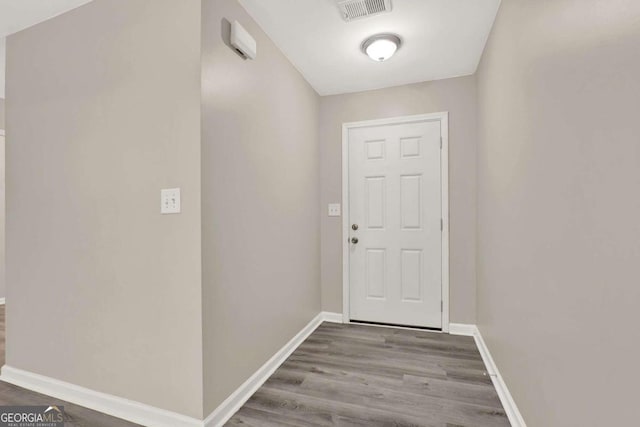 doorway with hardwood / wood-style flooring