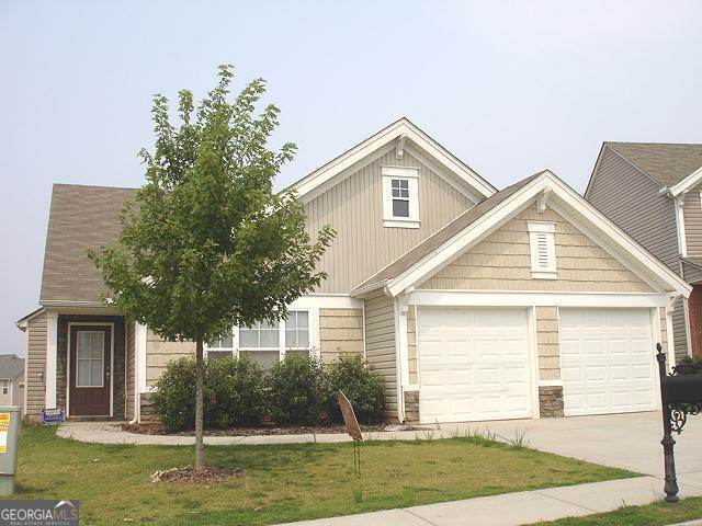 view of front of home with a garage and a front lawn