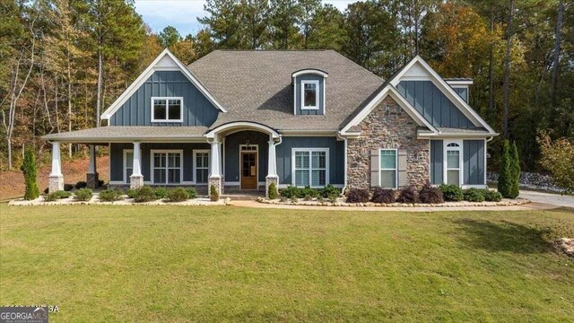 craftsman-style home with covered porch and a front lawn