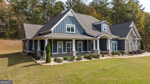 view of front of property with a porch and a front lawn