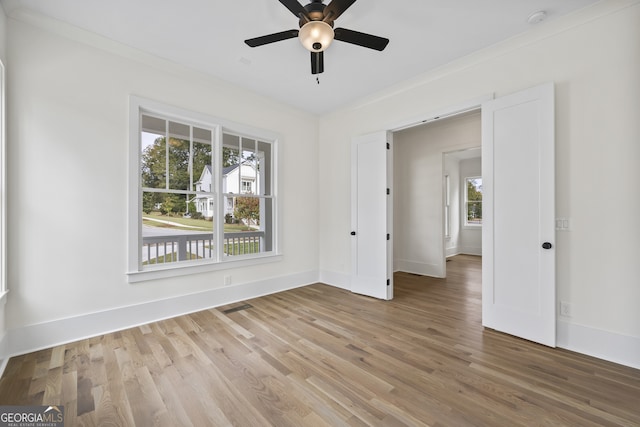 unfurnished room with crown molding, hardwood / wood-style flooring, and ceiling fan