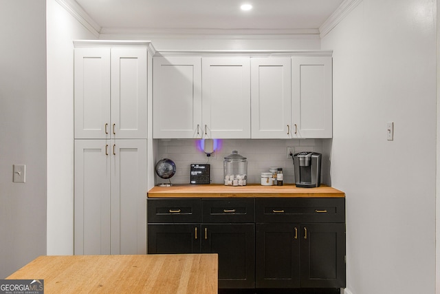 bar with white cabinets, backsplash, and ornamental molding