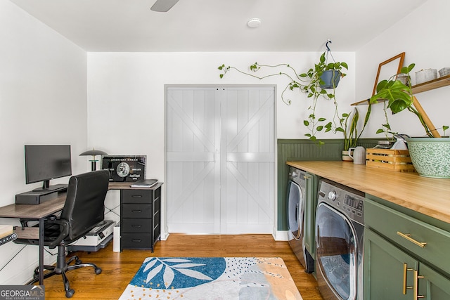 office space featuring hardwood / wood-style flooring and separate washer and dryer