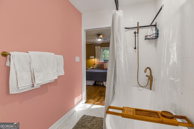 bathroom with hardwood / wood-style flooring, ceiling fan, and walk in shower