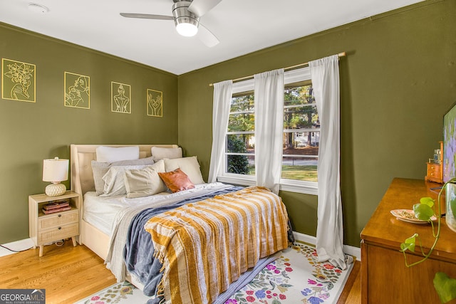 bedroom with light wood-type flooring and ceiling fan