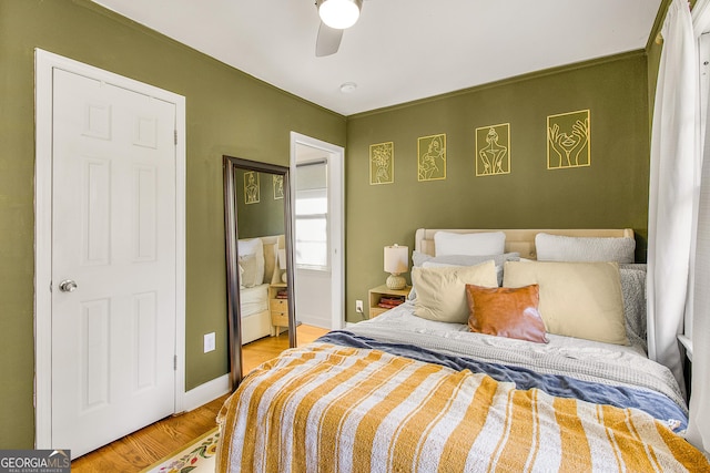 bedroom with light hardwood / wood-style floors and ceiling fan