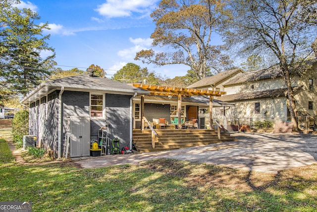 view of front of home featuring a deck, a patio area, a pergola, and a front yard