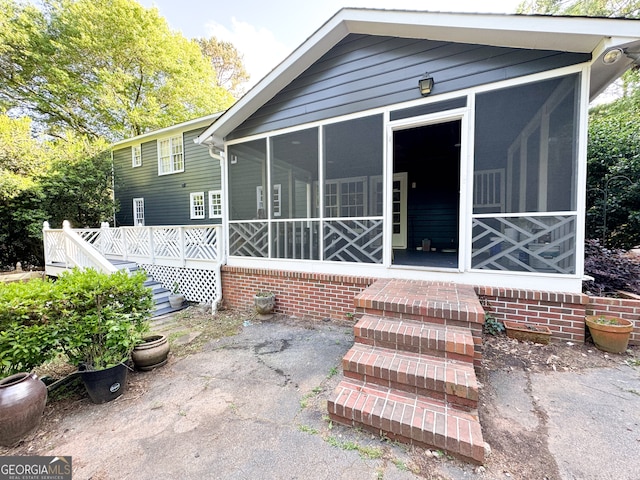 back of house with a sunroom