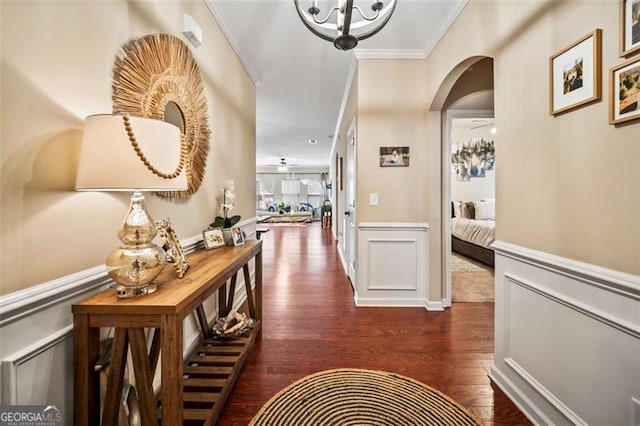 corridor featuring crown molding and dark hardwood / wood-style flooring